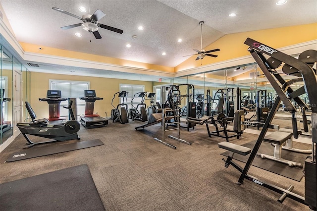 workout area with ceiling fan, a textured ceiling, carpet floors, and vaulted ceiling