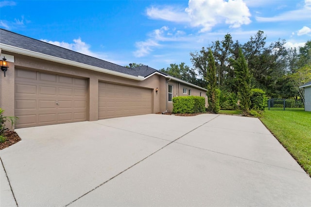 view of front of property with a garage and a front lawn