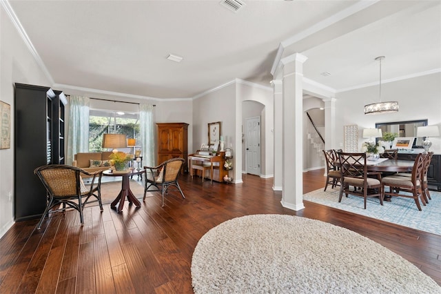 dining room featuring crown molding, dark wood-type flooring, and a chandelier