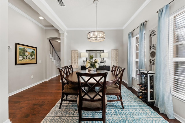 dining room with crown molding, dark wood-type flooring, and a wealth of natural light