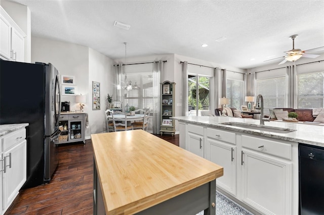 kitchen featuring dishwasher, dark hardwood / wood-style floors, white cabinetry, and sink