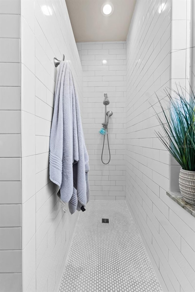 bathroom with a tile shower