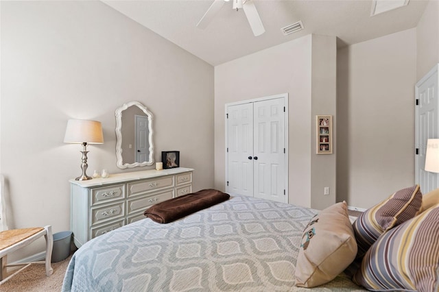 carpeted bedroom with lofted ceiling, ceiling fan, and a closet