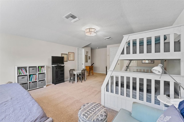 bedroom featuring carpet floors and a textured ceiling