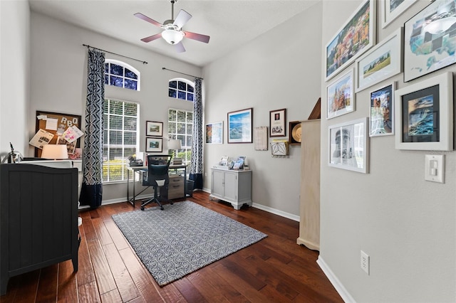 home office with ceiling fan and dark hardwood / wood-style floors