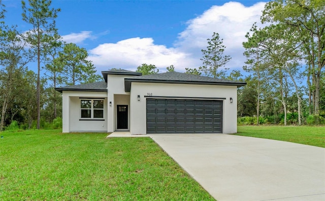 view of front of home featuring a front lawn and a garage