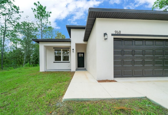 property entrance with a garage and a lawn