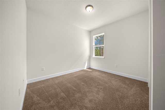 carpeted spare room featuring a textured ceiling