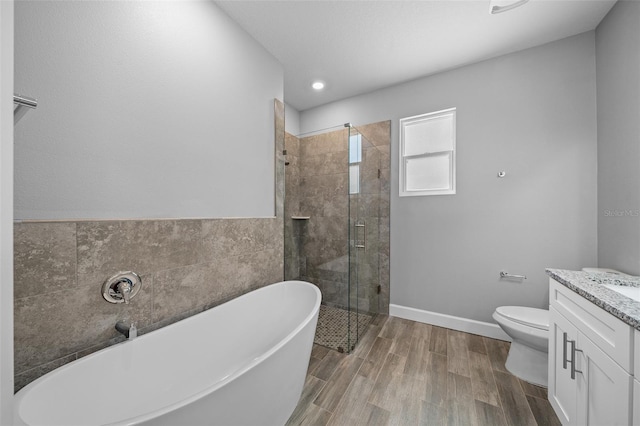 full bathroom with vanity, hardwood / wood-style floors, toilet, and separate shower and tub