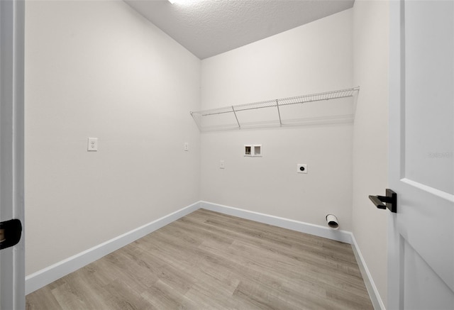 washroom featuring a textured ceiling, light wood-type flooring, hookup for an electric dryer, and washer hookup