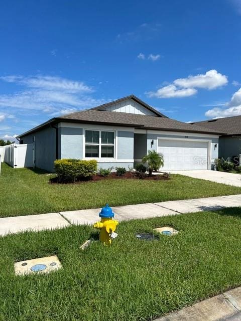 ranch-style house with a garage and a front yard