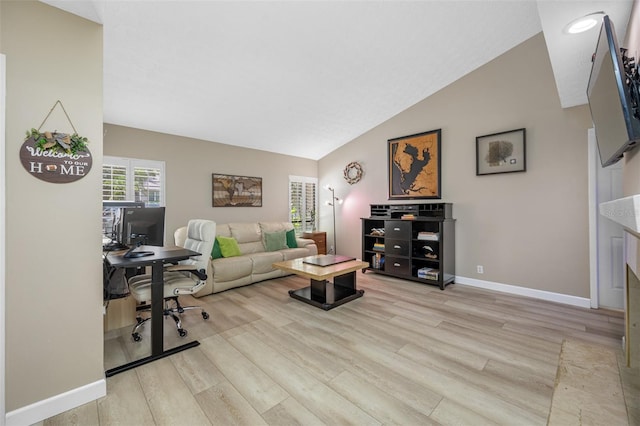 living room featuring light hardwood / wood-style flooring and vaulted ceiling