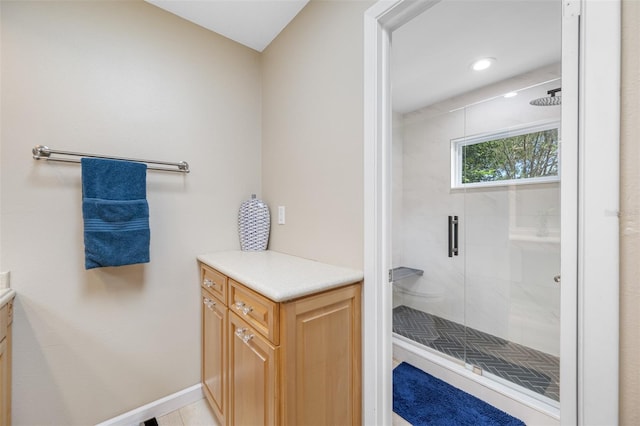 bathroom featuring tile patterned flooring, a shower with door, and vanity