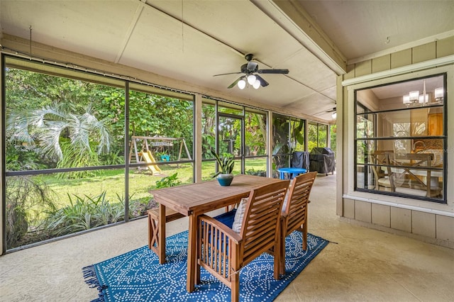 sunroom / solarium with ceiling fan with notable chandelier