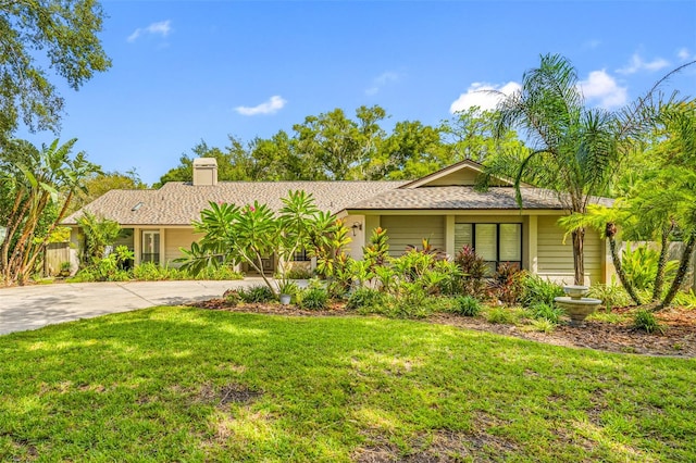 ranch-style home featuring a front yard