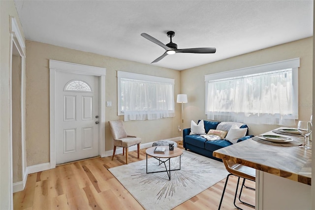 living room featuring ceiling fan and light wood-type flooring