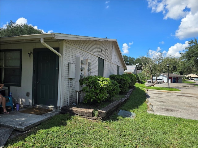 view of property exterior with a lawn