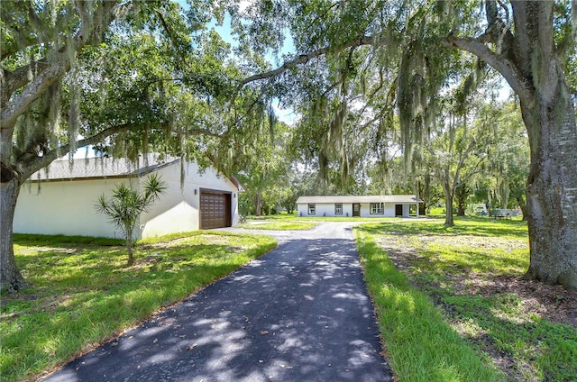 ranch-style home featuring a front yard