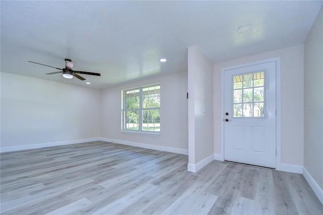 entryway featuring light hardwood / wood-style floors, a textured ceiling, plenty of natural light, and ceiling fan