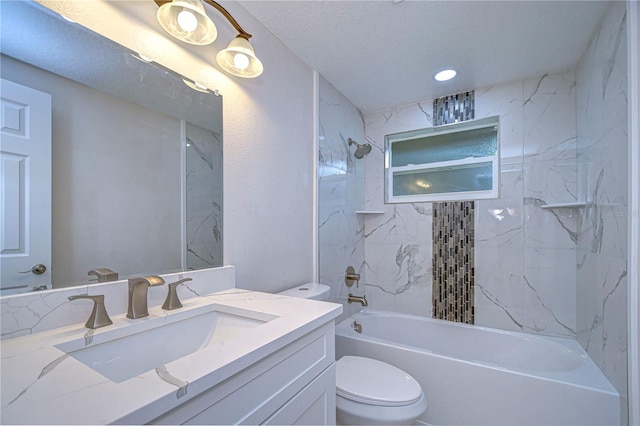 full bathroom featuring toilet, tiled shower / bath combo, vanity, and a textured ceiling