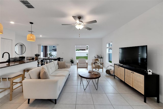 living room featuring ceiling fan and light tile patterned floors