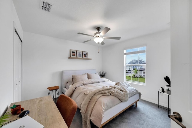 carpeted bedroom featuring a closet and ceiling fan