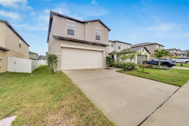 view of property with a front yard and a garage