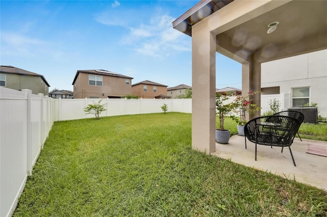 view of yard featuring central air condition unit and a patio area