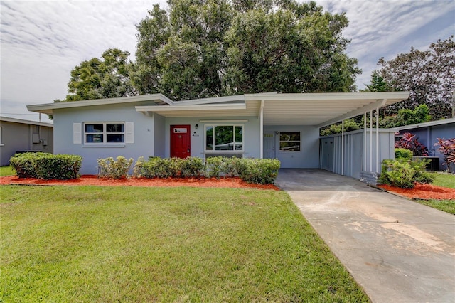 view of front of property with a front lawn and a carport