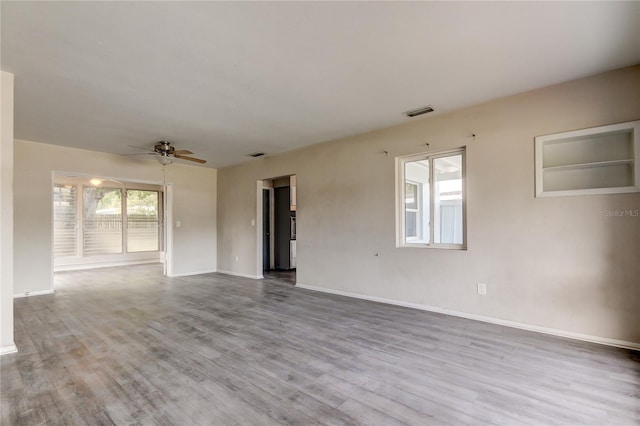 empty room featuring ceiling fan and light hardwood / wood-style floors