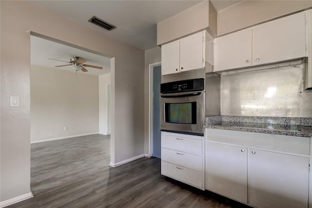 kitchen with ceiling fan, oven, dark wood-type flooring, light stone countertops, and white cabinets