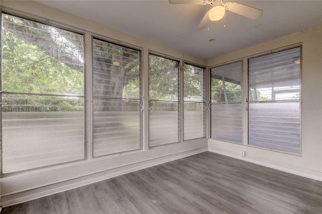 unfurnished sunroom with ceiling fan and a healthy amount of sunlight