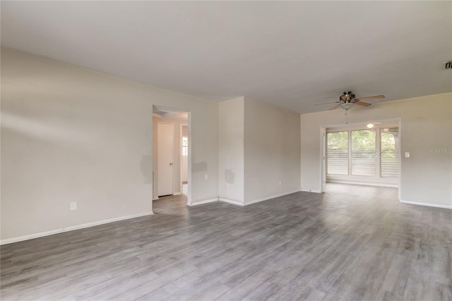 empty room featuring ceiling fan and hardwood / wood-style floors