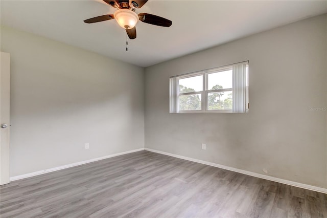 spare room with light wood-type flooring and ceiling fan