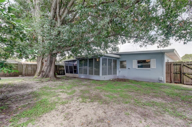 back of property with a sunroom