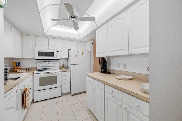 kitchen with decorative backsplash, white appliances, white cabinetry, and light tile patterned flooring