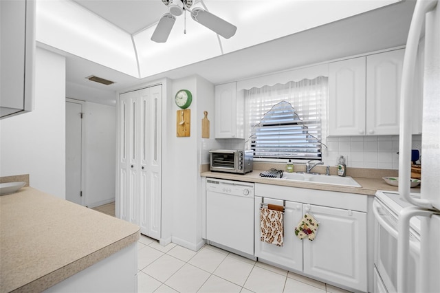 kitchen featuring backsplash, white appliances, white cabinetry, and sink