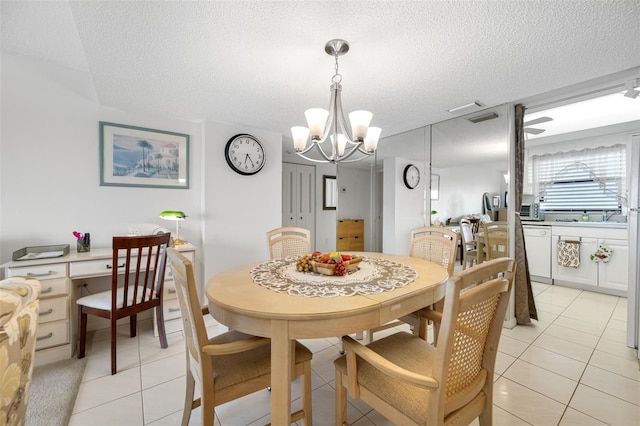 dining space with light tile patterned floors, a textured ceiling, and a chandelier