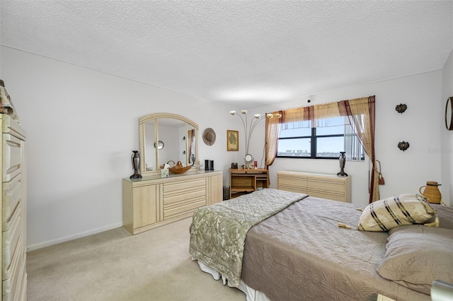 bedroom with a textured ceiling and light colored carpet