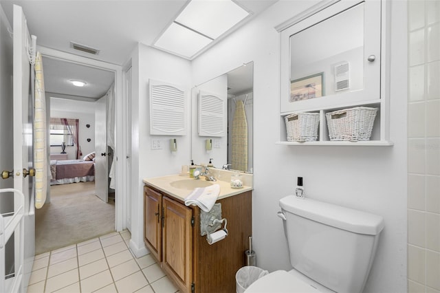 bathroom with tile patterned floors, vanity, and toilet