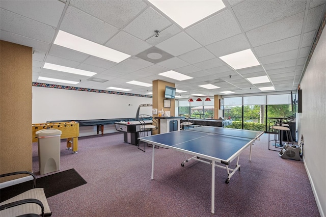 game room featuring a paneled ceiling and carpet flooring