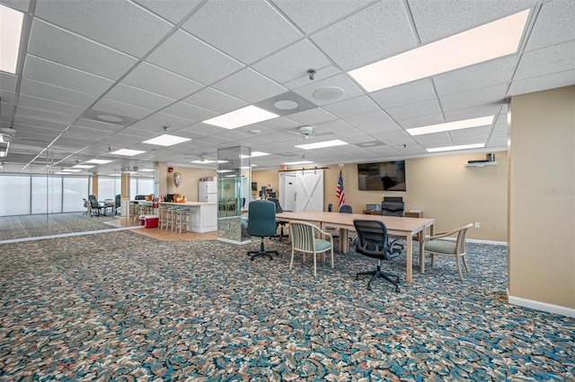 carpeted office space featuring a drop ceiling