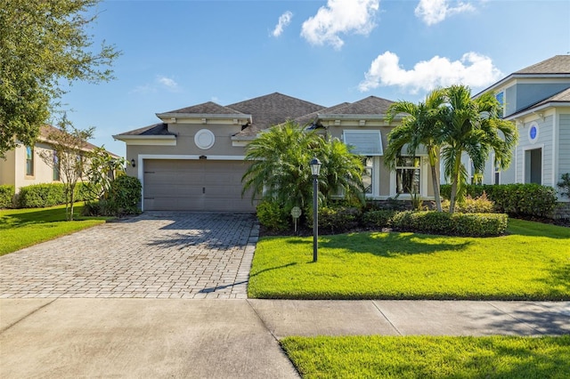 view of front facade with a front yard and a garage