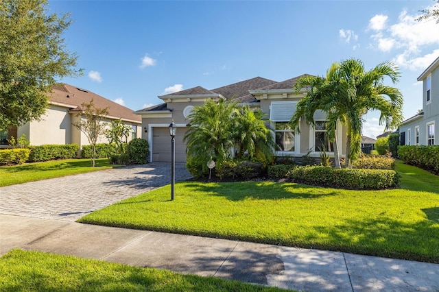 mediterranean / spanish-style home with a garage and a front lawn