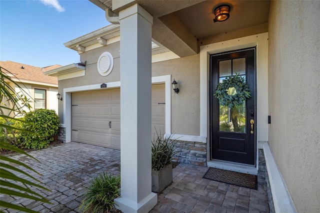 view of exterior entry featuring a garage