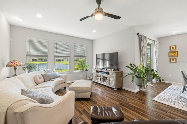 living room featuring dark hardwood / wood-style flooring and ceiling fan