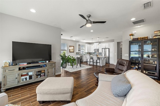 living room featuring hardwood / wood-style flooring and ceiling fan