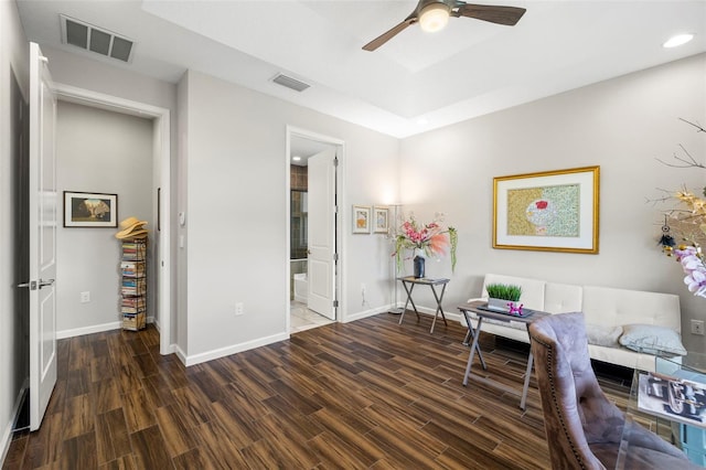 living area with ceiling fan and dark hardwood / wood-style floors