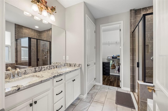 bathroom featuring an enclosed shower, vanity, and tile patterned floors