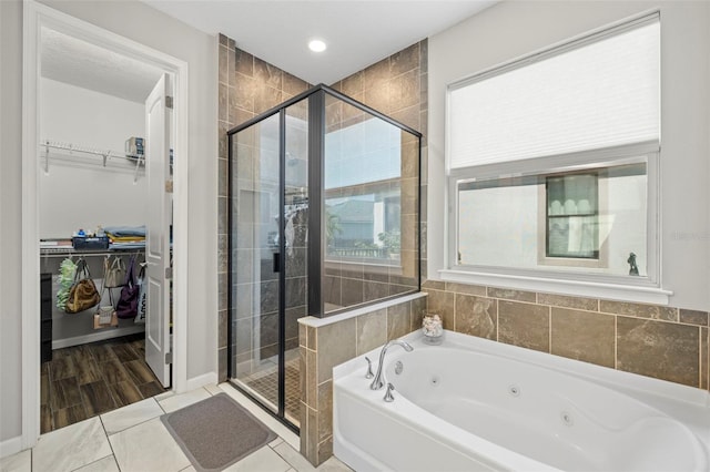 bathroom featuring hardwood / wood-style floors and separate shower and tub